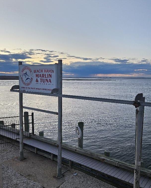 The Beach Haven Marlin & Tuna Club sign on the clubhouse dock at dusk